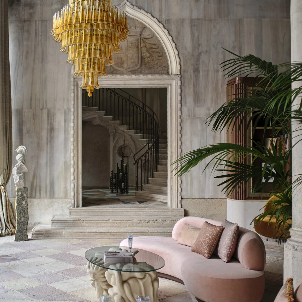 The grand lobby of Orient Express Venezia with Murano glass chandeliers and sculpted boiserie