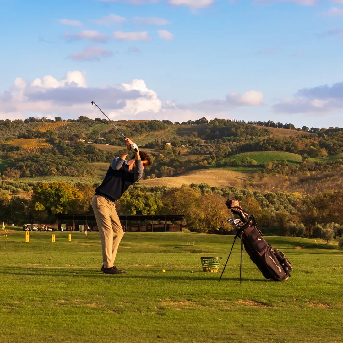 Golfer on scenic green hills along Northern Greens train route