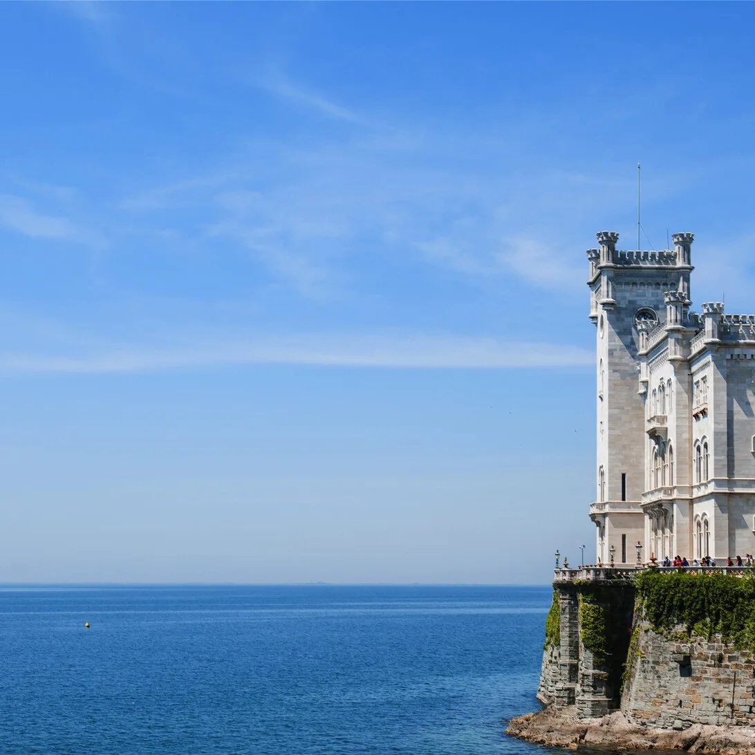 Ancient ruins overlooking dramatic coastal mountains