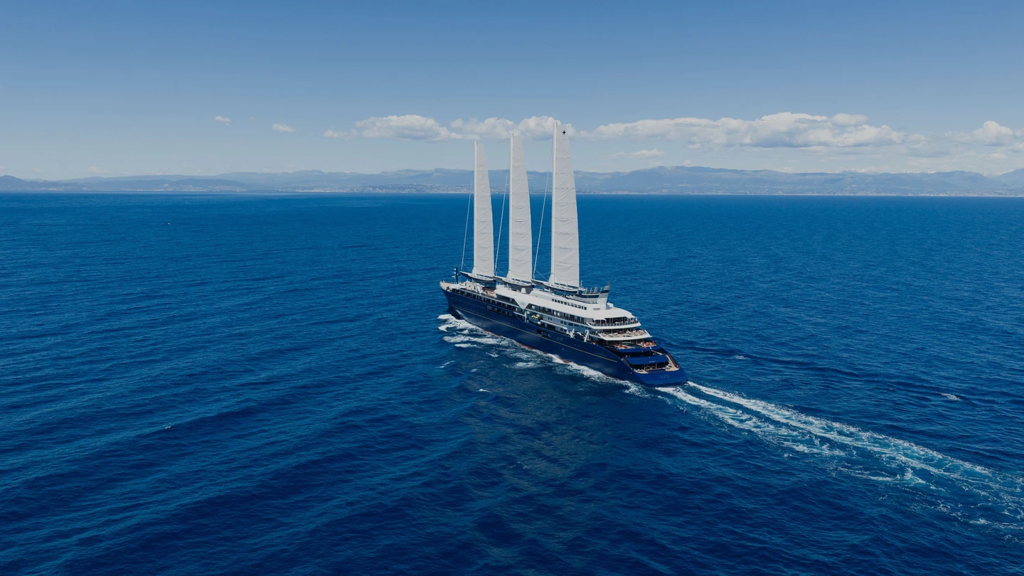 Orient Express Corinthian under her three tall rigid sails at sea