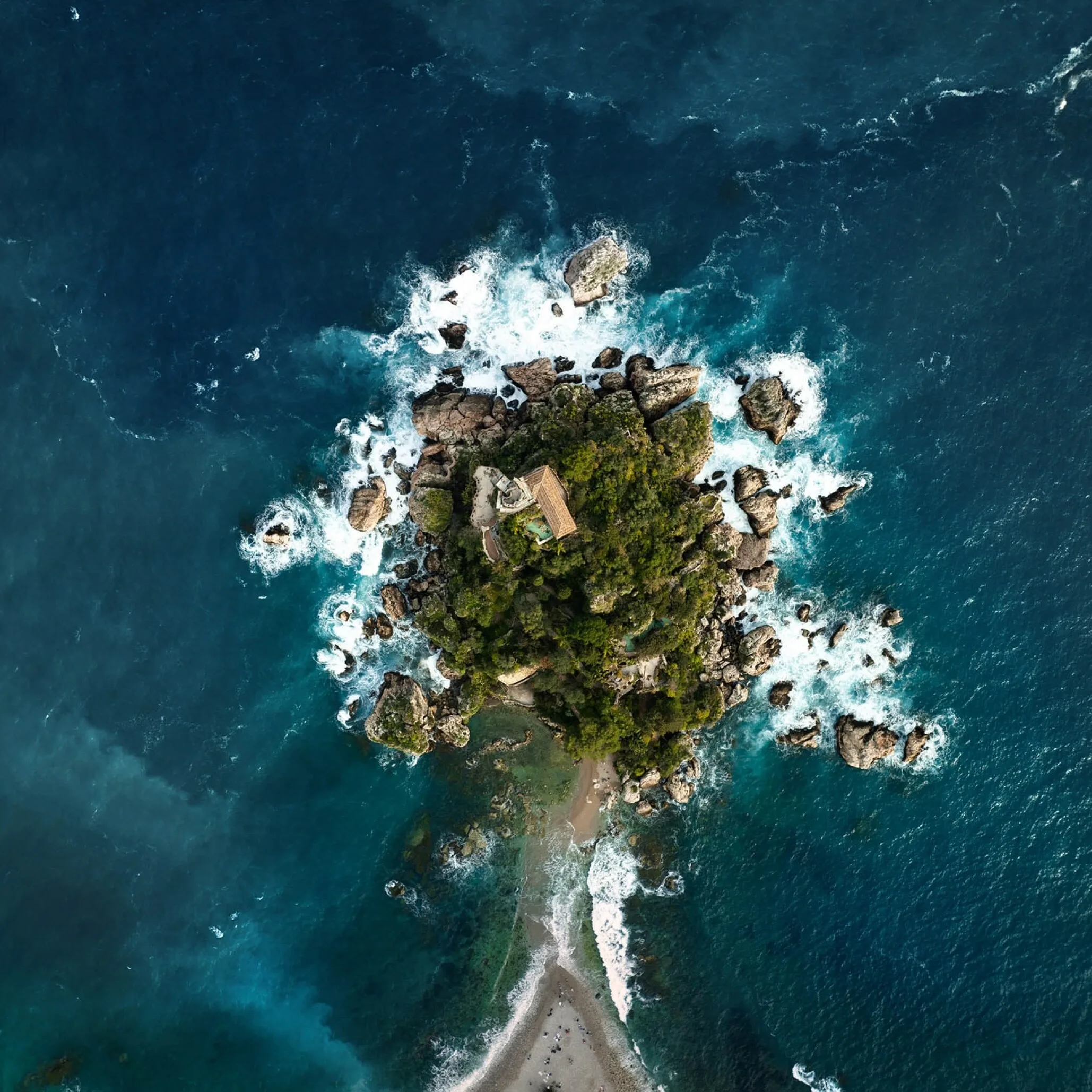Islet with villa and cypresses, waves crashing, narrow sandbar to the Sicilian coast — From Rome to Sicily