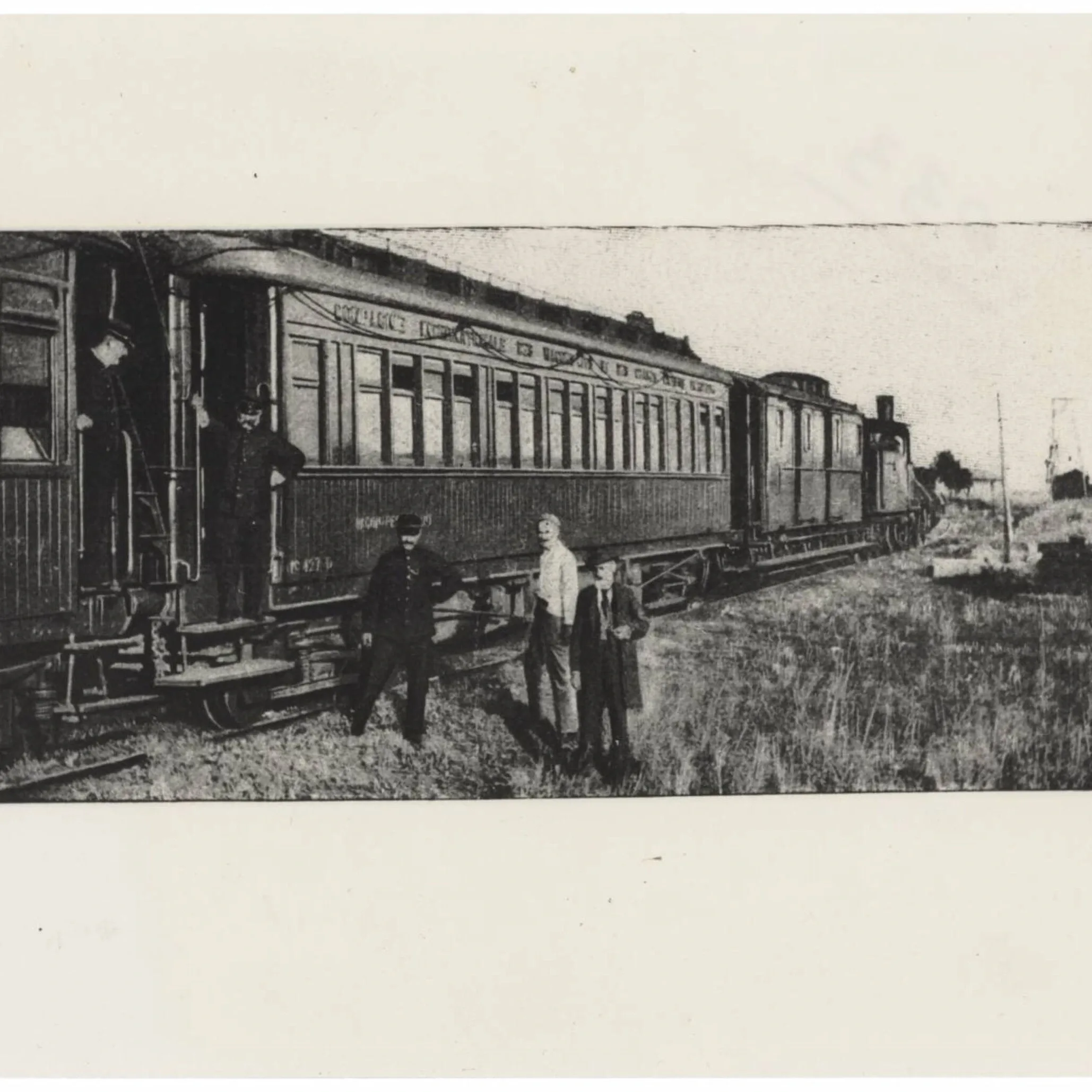 Orient Express carriage — men standing by vintage train on rural trackside in a historic black-and-white scene